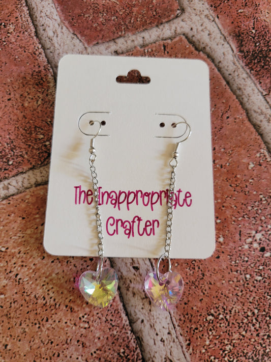 Pink crystal heart and silver chain earrings on a product card that says The Inappropriate Crafter shown on a brick background.
